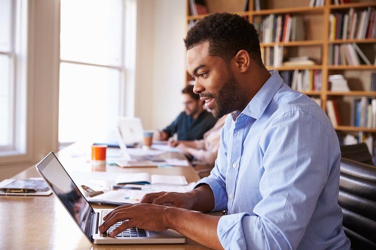 Man Planning Apartment Search on Laptop